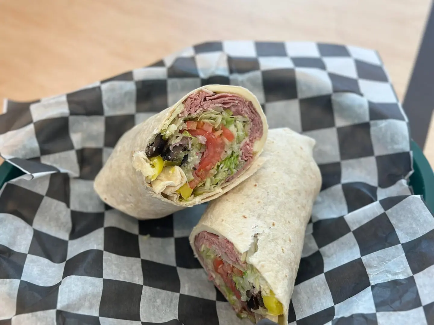 A close up of two burritos on a plate