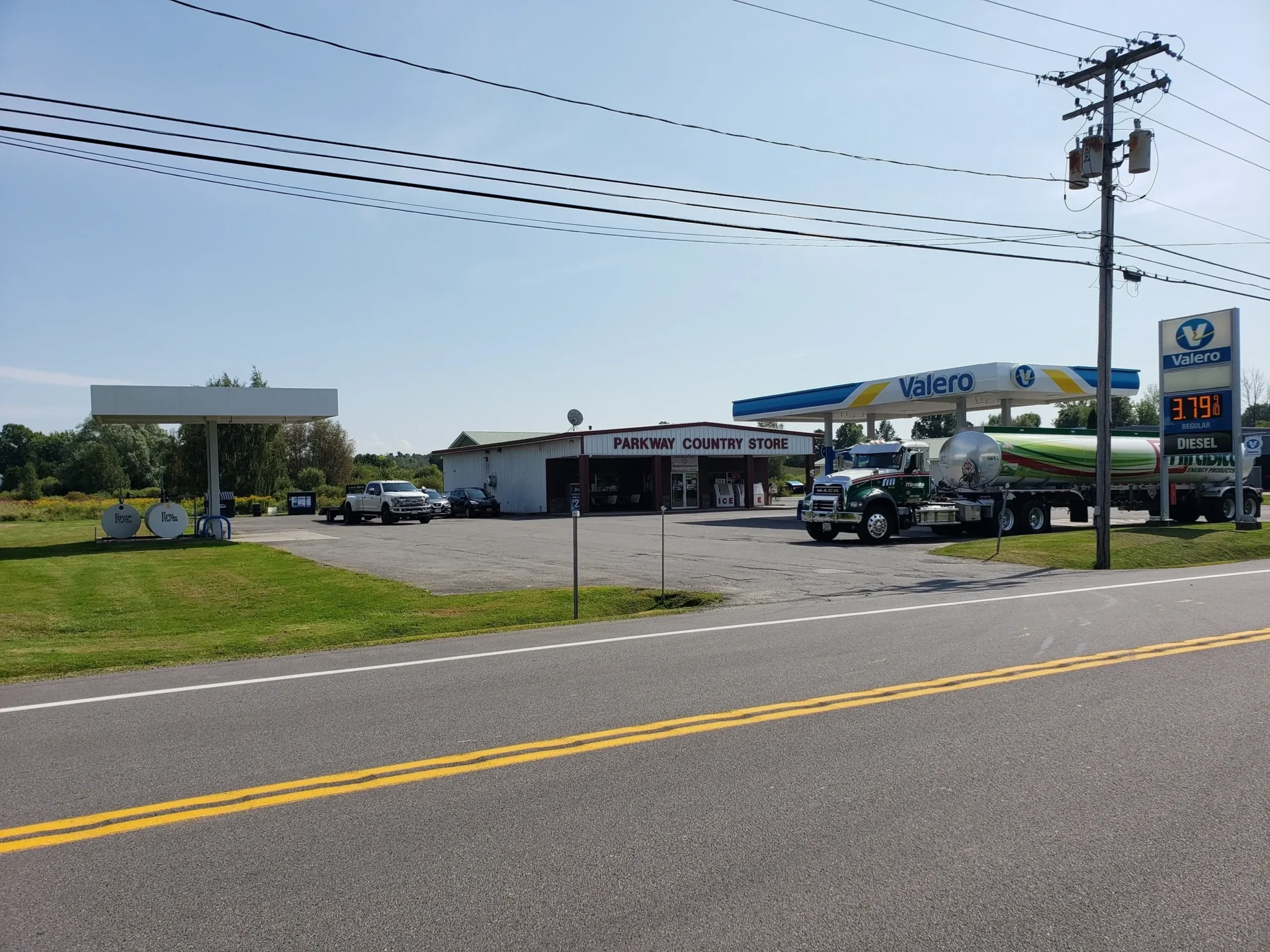 A truck parked in front of a gas station.