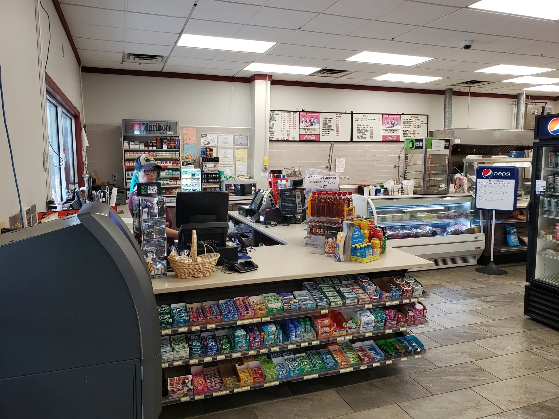 A convenience store with shelves of soda and other items.